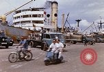 Image of Unloading of oil barrels Saigon Vietnam, 1966, second 15 stock footage video 65675037335