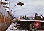Image of Unloading of oil barrels Saigon Vietnam, 1966, second 25 stock footage video 65675037335