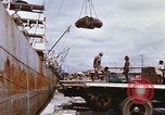 Image of Unloading of oil barrels Saigon Vietnam, 1966, second 32 stock footage video 65675037335