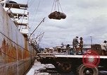 Image of Unloading of oil barrels Saigon Vietnam, 1966, second 33 stock footage video 65675037335