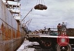 Image of Unloading of oil barrels Saigon Vietnam, 1966, second 37 stock footage video 65675037335