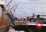 Image of Unloading of oil barrels Saigon Vietnam, 1966, second 40 stock footage video 65675037335