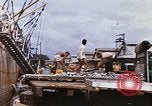 Image of Unloading of oil barrels Saigon Vietnam, 1966, second 41 stock footage video 65675037335