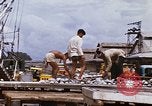 Image of Unloading of oil barrels Saigon Vietnam, 1966, second 42 stock footage video 65675037335