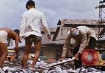 Image of Unloading of oil barrels Saigon Vietnam, 1966, second 44 stock footage video 65675037335
