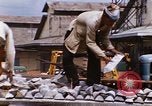 Image of Unloading of oil barrels Saigon Vietnam, 1966, second 45 stock footage video 65675037335