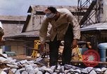 Image of Unloading of oil barrels Saigon Vietnam, 1966, second 46 stock footage video 65675037335