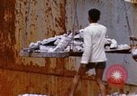 Image of Unloading of oil barrels Saigon Vietnam, 1966, second 48 stock footage video 65675037335