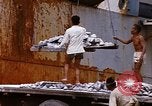 Image of Unloading of oil barrels Saigon Vietnam, 1966, second 49 stock footage video 65675037335