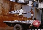 Image of Unloading of oil barrels Saigon Vietnam, 1966, second 50 stock footage video 65675037335