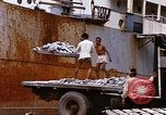 Image of Unloading of oil barrels Saigon Vietnam, 1966, second 52 stock footage video 65675037335