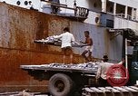 Image of Unloading of oil barrels Saigon Vietnam, 1966, second 53 stock footage video 65675037335