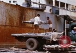 Image of Unloading of oil barrels Saigon Vietnam, 1966, second 54 stock footage video 65675037335