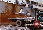 Image of Unloading of oil barrels Saigon Vietnam, 1966, second 55 stock footage video 65675037335