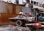 Image of Unloading of oil barrels Saigon Vietnam, 1966, second 56 stock footage video 65675037335