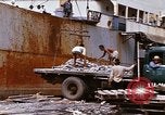 Image of Unloading of oil barrels Saigon Vietnam, 1966, second 57 stock footage video 65675037335