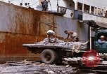 Image of Unloading of oil barrels Saigon Vietnam, 1966, second 58 stock footage video 65675037335