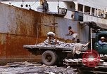 Image of Unloading of oil barrels Saigon Vietnam, 1966, second 59 stock footage video 65675037335