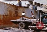 Image of Unloading of oil barrels Saigon Vietnam, 1966, second 60 stock footage video 65675037335