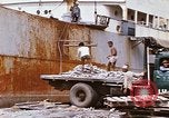 Image of Unloading of oil barrels Saigon Vietnam, 1966, second 61 stock footage video 65675037335