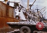 Image of Unloading of oil barrels Saigon Vietnam, 1966, second 62 stock footage video 65675037335