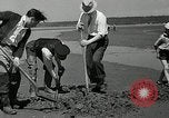 Image of goeduck clam digging Tacoma Washington USA, 1935, second 21 stock footage video 65675037671