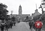 Image of 1st Infantry march past church of Sainte Marie du Mont Sainte Marie du Mont France, 1944, second 19 stock footage video 65675038186