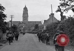 Image of 1st Infantry march past church of Sainte Marie du Mont Sainte Marie du Mont France, 1944, second 25 stock footage video 65675038186