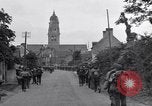 Image of 1st Infantry march past church of Sainte Marie du Mont Sainte Marie du Mont France, 1944, second 26 stock footage video 65675038186