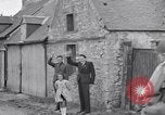 Image of 1st Infantry march past church of Sainte Marie du Mont Sainte Marie du Mont France, 1944, second 29 stock footage video 65675038186