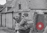 Image of 1st Infantry march past church of Sainte Marie du Mont Sainte Marie du Mont France, 1944, second 30 stock footage video 65675038186