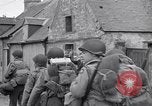 Image of 1st Infantry march past church of Sainte Marie du Mont Sainte Marie du Mont France, 1944, second 32 stock footage video 65675038186