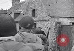 Image of 1st Infantry march past church of Sainte Marie du Mont Sainte Marie du Mont France, 1944, second 33 stock footage video 65675038186