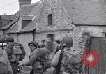 Image of 1st Infantry march past church of Sainte Marie du Mont Sainte Marie du Mont France, 1944, second 34 stock footage video 65675038186