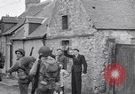Image of 1st Infantry march past church of Sainte Marie du Mont Sainte Marie du Mont France, 1944, second 35 stock footage video 65675038186