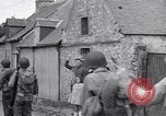 Image of 1st Infantry march past church of Sainte Marie du Mont Sainte Marie du Mont France, 1944, second 36 stock footage video 65675038186