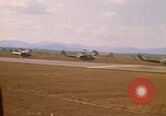 Image of long line of UH-1 Helicopters Pleiku Vietnam, 1970, second 14 stock footage video 65675038743