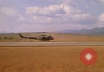 Image of long line of UH-1 Helicopters Pleiku Vietnam, 1970, second 17 stock footage video 65675038743