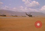 Image of long line of UH-1 Helicopters Pleiku Vietnam, 1970, second 20 stock footage video 65675038743