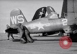 Image of F4U airplanes being moved on USS Badoeng Strait (CVE – 116) Pacific Ocean, 1950, second 4 stock footage video 65675040316