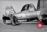 Image of F4U airplanes being moved on USS Badoeng Strait (CVE – 116) Pacific Ocean, 1950, second 5 stock footage video 65675040316