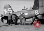 Image of F4U airplanes being moved on USS Badoeng Strait (CVE – 116) Pacific Ocean, 1950, second 12 stock footage video 65675040316