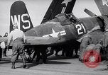 Image of F4U airplanes being moved on USS Badoeng Strait (CVE – 116) Pacific Ocean, 1950, second 23 stock footage video 65675040316