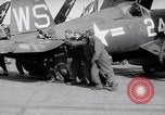 Image of F4U airplanes being moved on USS Badoeng Strait (CVE – 116) Pacific Ocean, 1950, second 50 stock footage video 65675040316