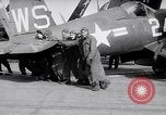 Image of F4U airplanes being moved on USS Badoeng Strait (CVE – 116) Pacific Ocean, 1950, second 51 stock footage video 65675040316