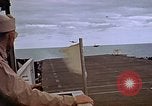 Image of General Motors FM-2 Wildcat aircraft landing on escort carrier Iwo Jima, 1945, second 52 stock footage video 65675040327