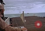Image of General Motors FM-2 Wildcat aircraft landing on escort carrier Iwo Jima, 1945, second 53 stock footage video 65675040327