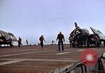 Image of Crews pushing FM-2 wildcat airplanes on escort carrier deck Iwo Jima, 1945, second 30 stock footage video 65675040329