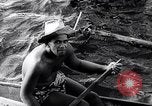 Image of Pacific Islanders in dugout canoes Pacific Theater, 1942, second 32 stock footage video 65675040839