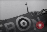 Image of British ground crewman assist RAF pilots of Spitfire fighter planes England United Kingdom, 1940, second 38 stock footage video 65675041005